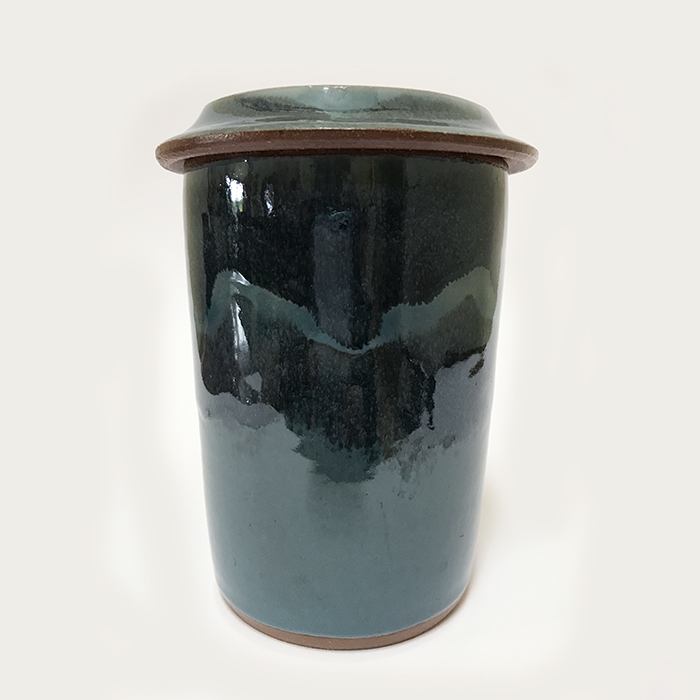 Item 447<br>Blue-glazed brown stoneware lidded pot, 6.0 in tall x 4.5 in wide.<br><b>$60</b>