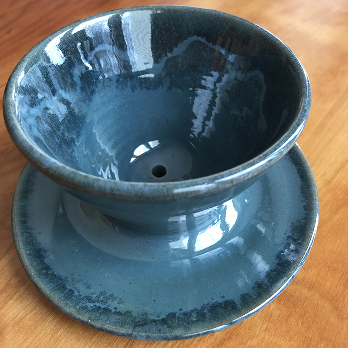 Item 458<br>Blue glazed white stoneware coffee pour over, 3.75 in wide x 4.5 in tall. Suitable for #4 paper cone filters to make a single serving of coffee.<br>