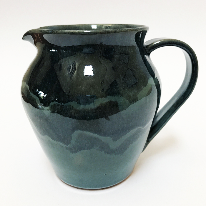 Item 492<br>Blue-glazed tall brown stoneware pitcher, 5.0 in tall x 4.25 in wide. Appropriate for maple syrup, sauces, or as a flower vase. Holds just over 16 oz. of liquid.<br><b>$50</b>
