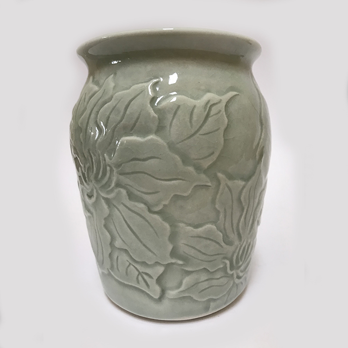 Item 123<br>Porcelain vase with carved clematis flowers in an aqua celadon glaze<br>4.75 in tall x 3.75 in wide<br><b>Sold</b>