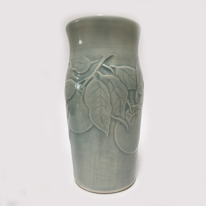 Item 126<br>Porcelain vase with carved peaches and leaves in an aqua celadon glaze<br>7.0 in tall x 3.5 in wide<br><b>Sold</b>