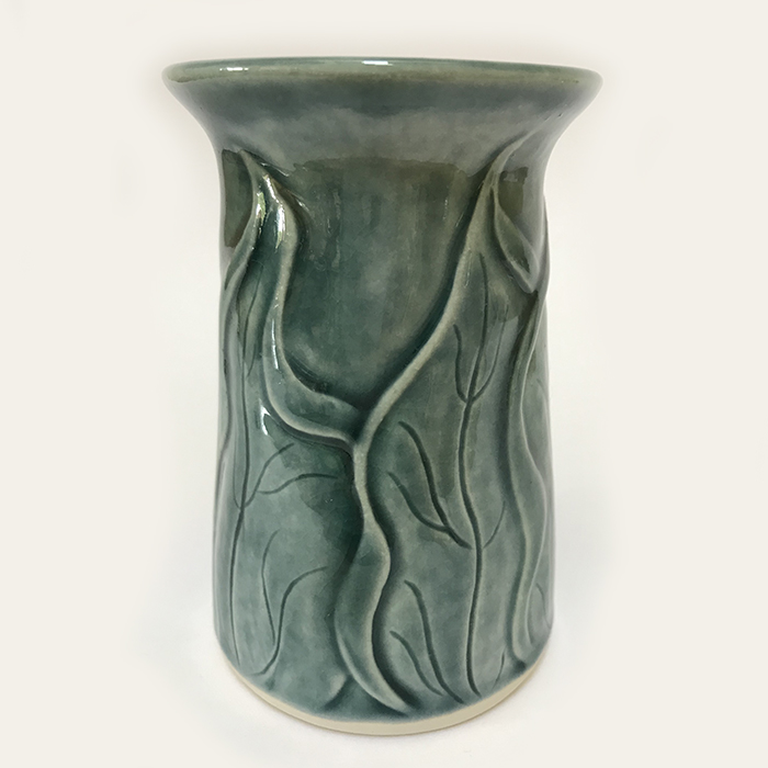 Item 134<br>Porcelain bud vase with carved leaves in a teal green celadon glaze<br>4.5 in tall x 3.0 in wide<br><b>Sold</b>