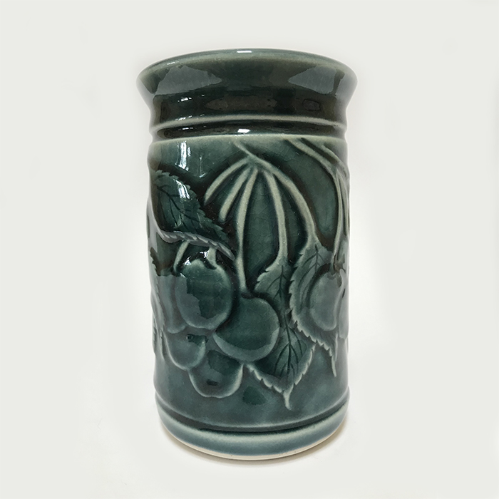 Item 282<br>Porcelain vase with carved cherries and leaves in a teal green celadon glaze<br>5.5 in tall x 3.25 in wide<br><b>Sold</b>