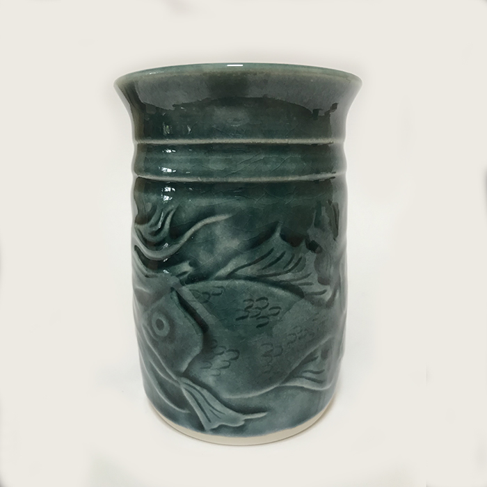 Item 283<br>Porcelain vase or tumbler with carved fish in a teal green celadon glaze<br>4.5 in tall x 3.0 in wide<br><b>Sold</b>