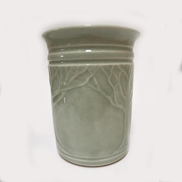 Item 3<br>Porcelain vase with carved trees and branches. Aqua celadon glaze<br>5.0 in tall x 4.0 in wide<br><b>Sold</b>