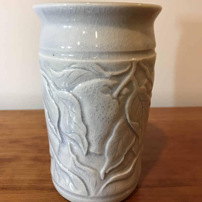 Item 4<br>Porcelain vase with carved peaches and leaves in an aqua celadon glaze<br>5.75 in tall x 3.75 in wide<br><b>Sold</b>