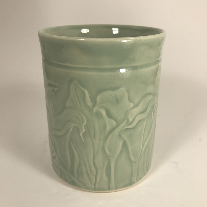 Light aqua celadon glazed white stoneware pot with carved calla lilies<br>5.25 in tall x 4 in wide<br><b>Sold</b>