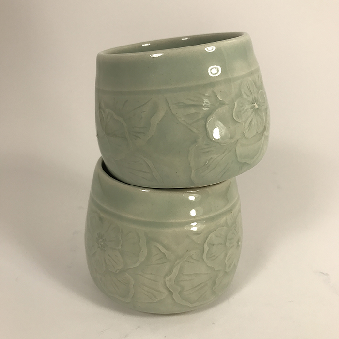 Item 602<br>light aqua celadon glazed teacups with carved flowers<br>2.25 in x 3 in and 2.5 in x 3 in<br><b>$40 each (only 1 left)</b>