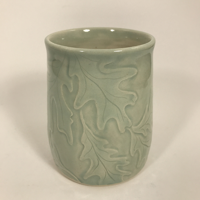 Item 664<br>Hand carved oak leaves tumbler, 4 inches tall x 3.25 inches in diameter<br><b>Sold</b>