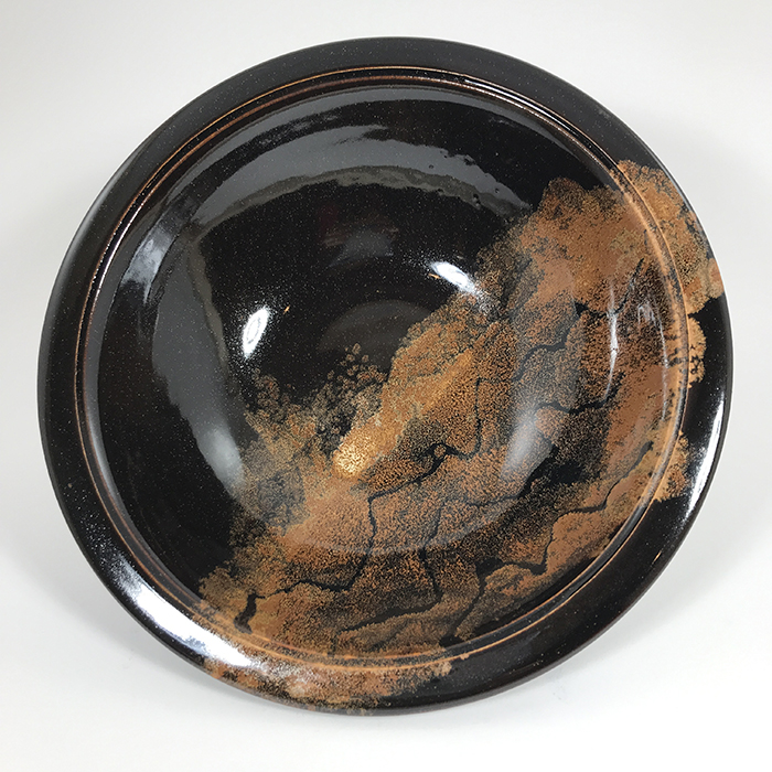 Item 607<br>Large bowl with copper and black glaze, 2.5 inches tall x 9 inches in diameter<br><b>$50</b>