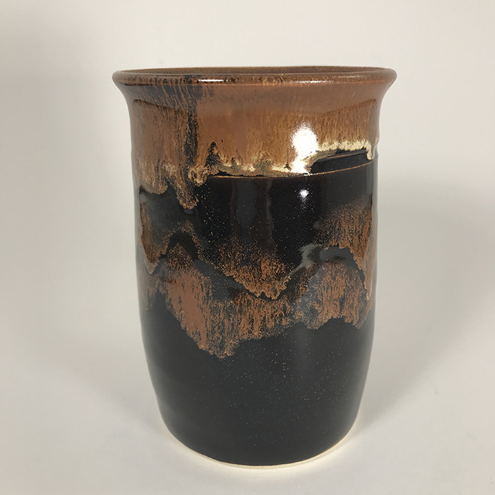 Item 704<br>Black and copper-glazed vase, 6 inches tall x 4 inches in diameter<br><b>$40</b>