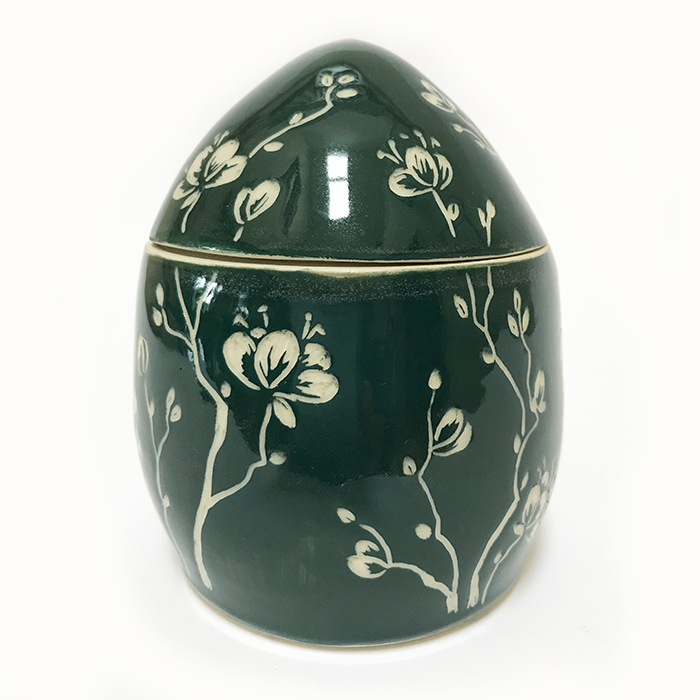 Item 437<br>Dark green sgraffito lidded pot with carved cherry blossoms<br>4.0 in tall x 3.25 in wide<br><b>Sold</b>