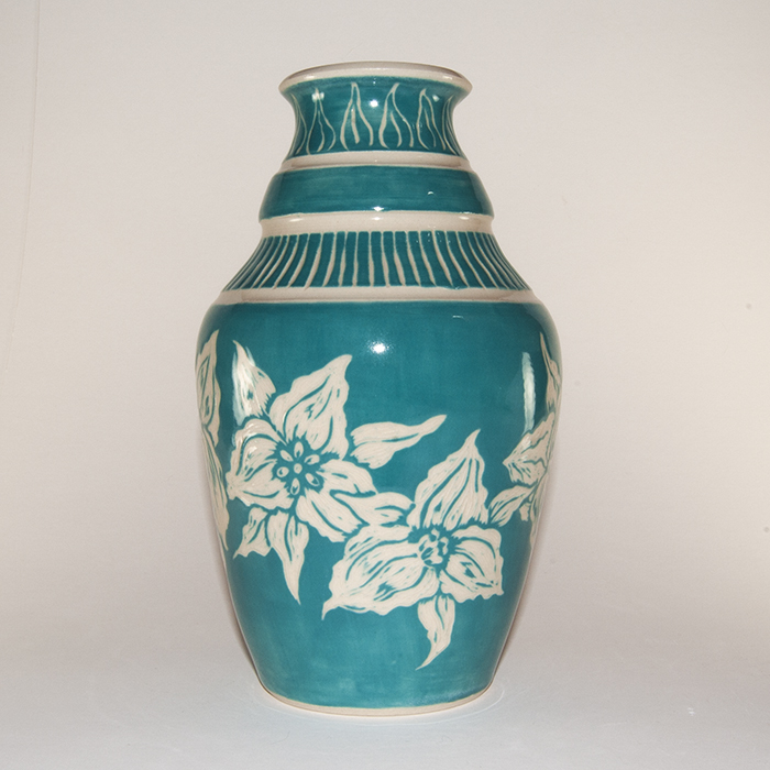 Item 512<br>Turquoise sgraffito vase with carved Trillium Flowers<br>7.5 in tall x 3.5 in wide on white stoneware<br><b>$125</b>