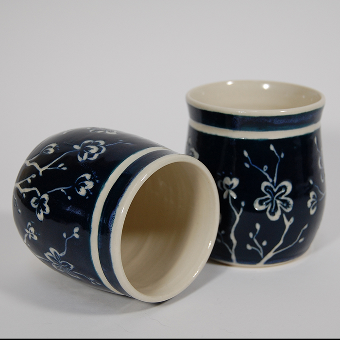 Item 538<br>Navy blue sgraffito cups with carved cherry blossoms<br>3.0 in wide x 3.25 in tall (only one available)<br><b>Sold</b>