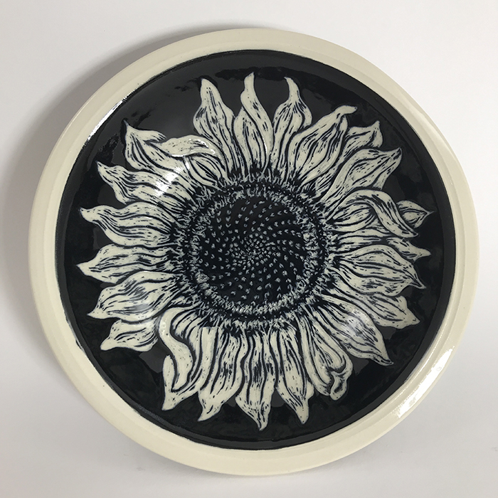 Item 635<br>Black sgraffito bowl on white stoneware with carved sunflower inside and leaves outside<br>1.75 in tall x 8.25 in wide<br><b>Sold</b>