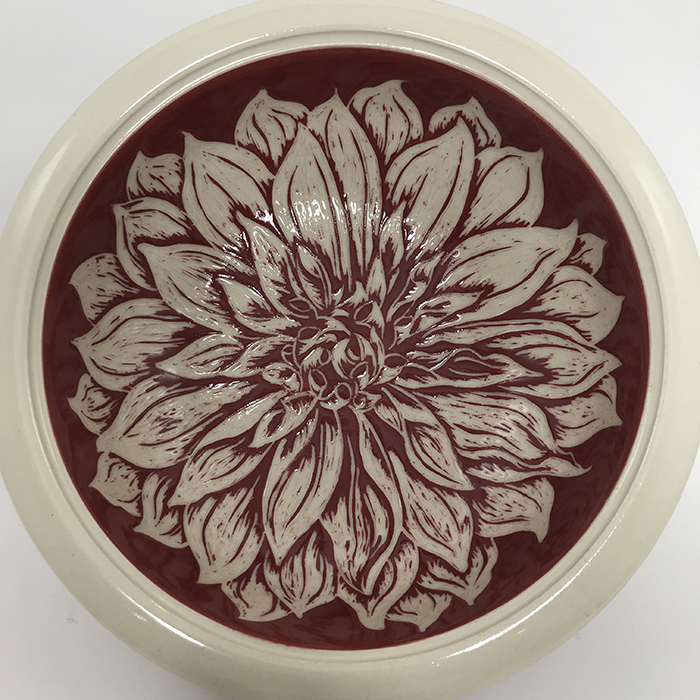 Item 637<br>Red sgraffito bowl on white stoneware with carved dahlia flower inside and leaves outside<br>2.5 in tall x 8.0 in wide<br>