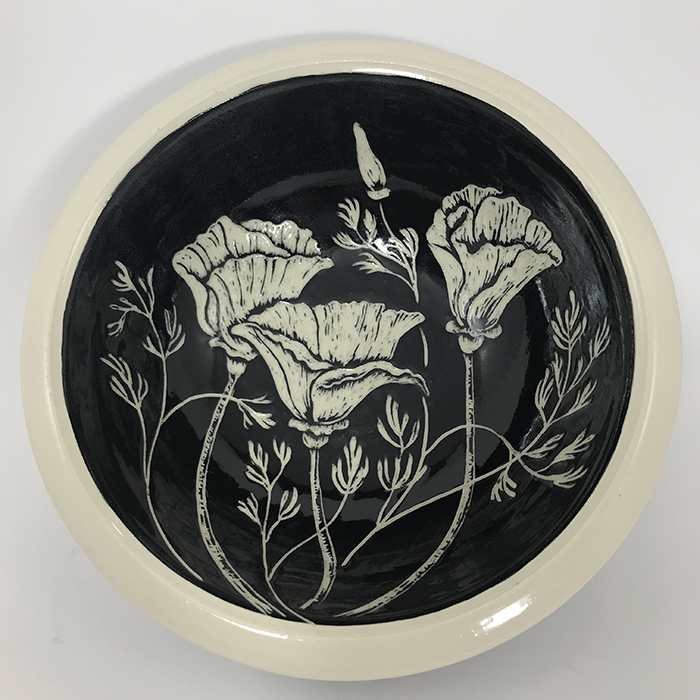 Item 647a<br>Black sgraffito bowl on white stoneware with carved poppy flowers on inside and flower buds and leaves on outside band<br>2.25 in tall x 8 in wide<br><b>Sold</b>