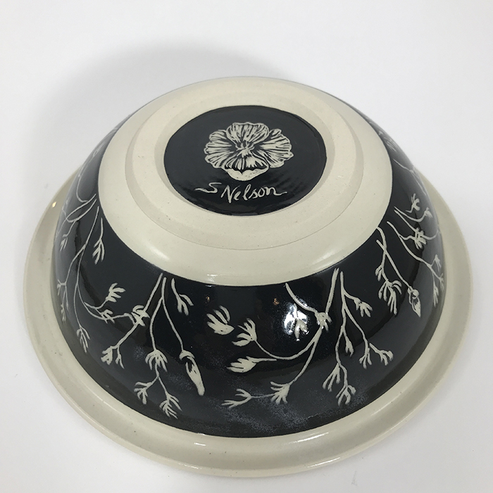 Item 647b<br>Black sgraffito bowl on white stoneware with carved poppy flowers on inside and flower buds and leaves on outside band<br>2.25 in tall x 8 in wide<br><b>Sold</b>