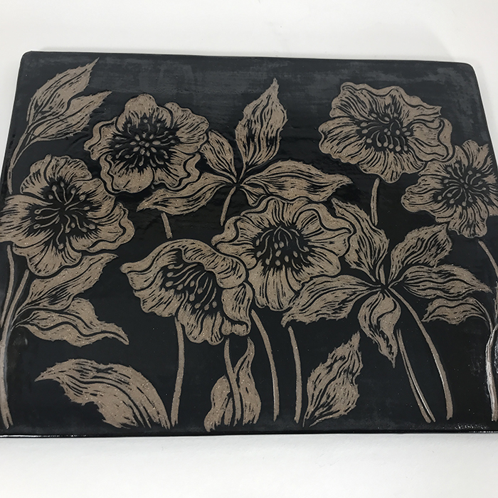 Item 696<br>Black sgraffito tile with lenten roses<br>7.0 in x 8.75 in