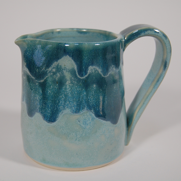 Item 543<br>Turquoise-glazed white stoneware pitcher for cream or sauces, 3.5 in tall x 3.0 in wide. Holds 7 oz.<br><b>Sold</b>