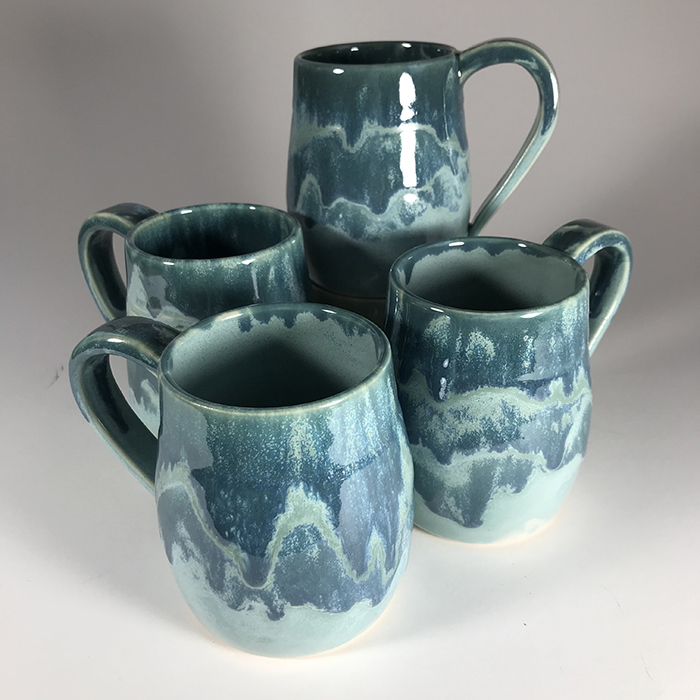 Item 560<br>Set of four turquoise glazed mugs, 4 in tall x 3 in wide<br><b>Sold</b>